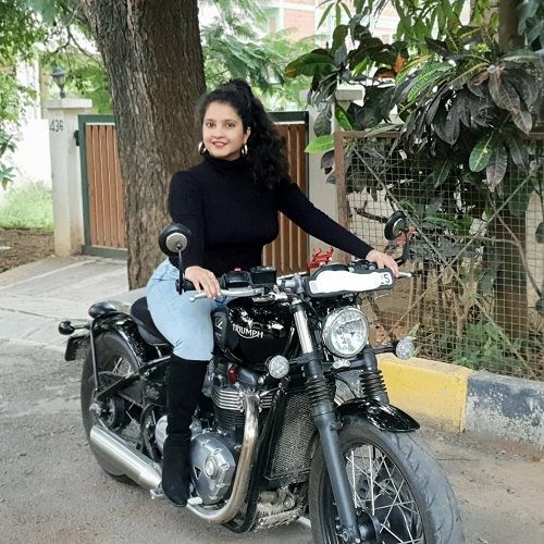 Shubha Poonja posant sur sa moto