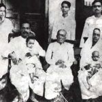 AC Bhaktivedanta Swami Prabhupada עם משפחתו (1924), משמאל אשתו Radharani (עומדת), Swami Prabhupada (יושב עם בנו Prayag Raj), אביו Gaur Mohan De (יושב), האחיין שלו Tulsi (עומד, האחורי של Gaur Mohan De), אחותו Rajesvari עם בתו Sulakshman (בישיבה), אחיו Krishna Charan (עומד)