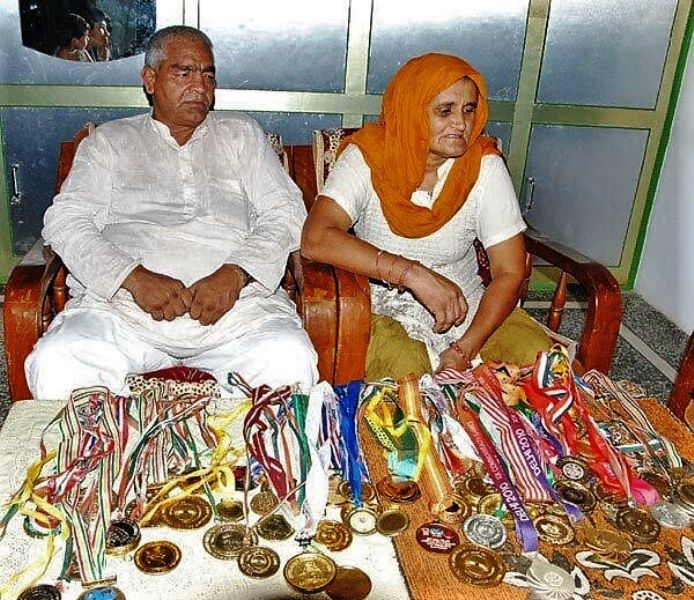 Родители на Geeta и Babita Phogat С медалите на дъщерите си